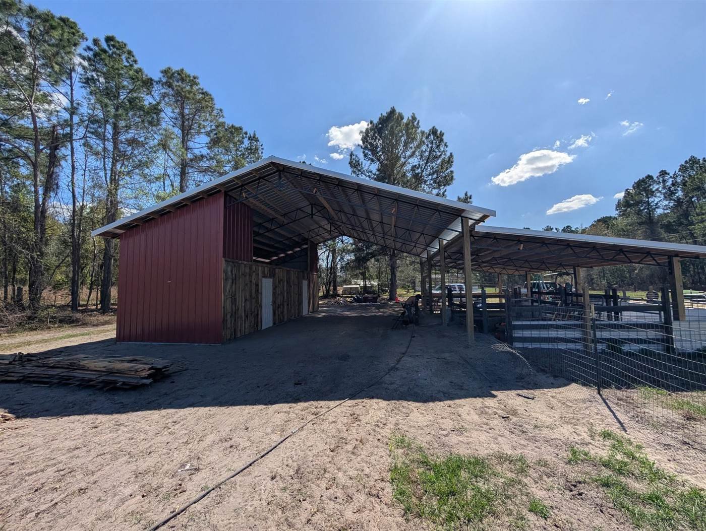 Pole barn with red siding built by Carlton Land Management